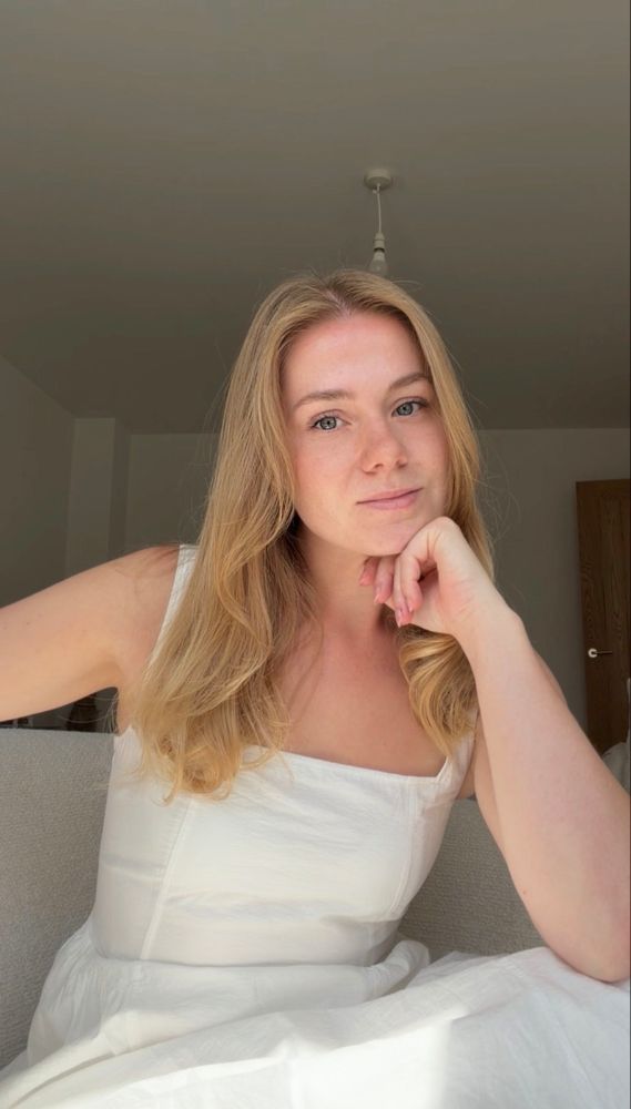 Molly Allen sitting at a desk, smiling
