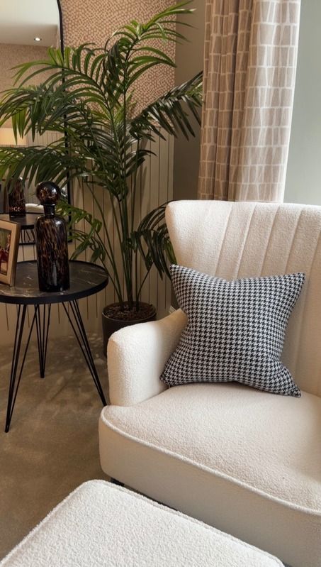 Cream armchair beside a plant